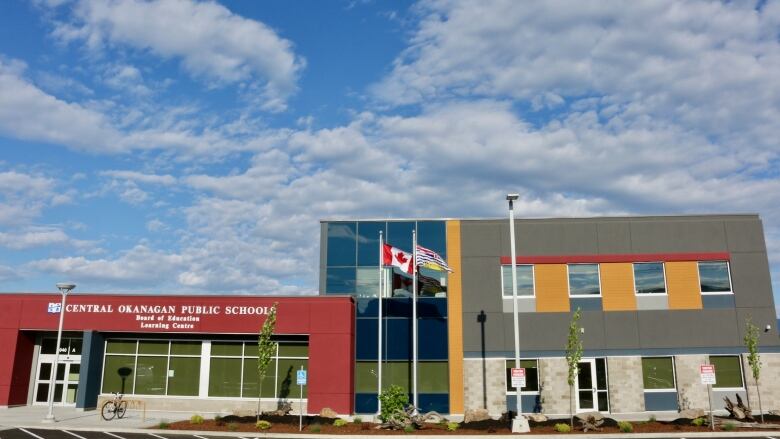 A school building, with the name 'Central Okanagan Public School' visible.