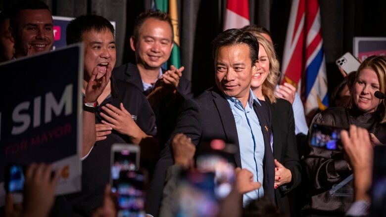 Ken Sim celebrates his win as the next mayor of Vancouver, marking the first time a person of colour has held the highest office in the city, on Saturday, Oct. 15, 2022. 