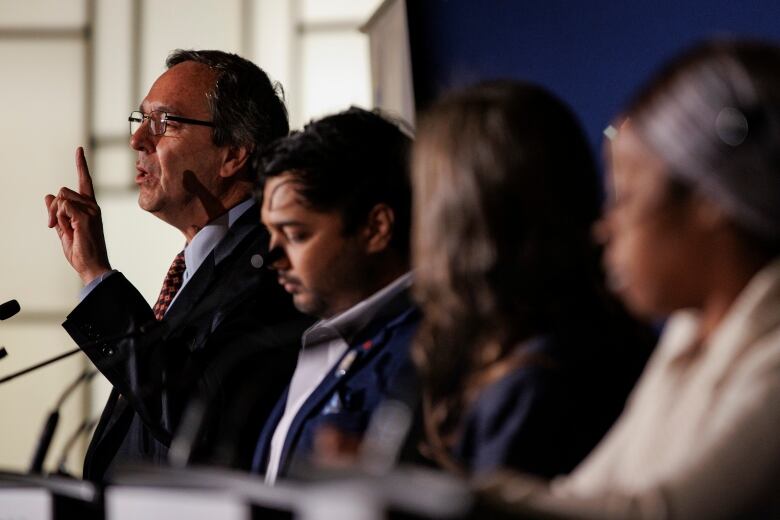 Toronto mayoral candidate Gil Penalosa, left, takes part in the Toronto Regional Board of Trade debate, at the Carlu, in Toronto, on Oct. 17, 2022.