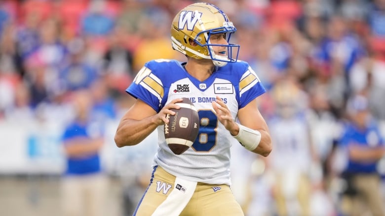 A football player holding a ball 