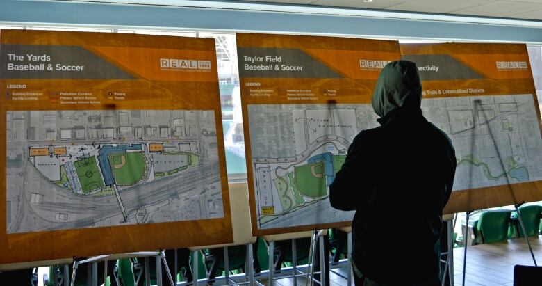 A Regina resident views some of the information boards about five potential projects that could shape the city's downtown for decades to come. 