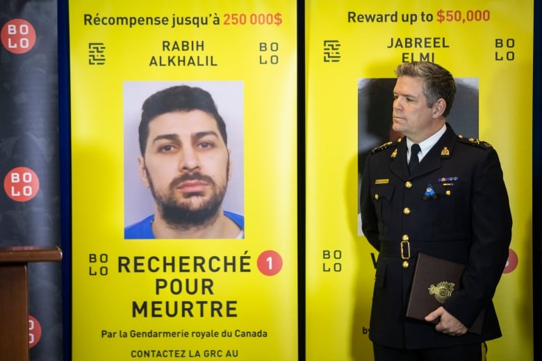 RCMP deputy commissioner Dwayne McDonald stands next to a wanted sign for fugitive Rabih Alkhalil. 