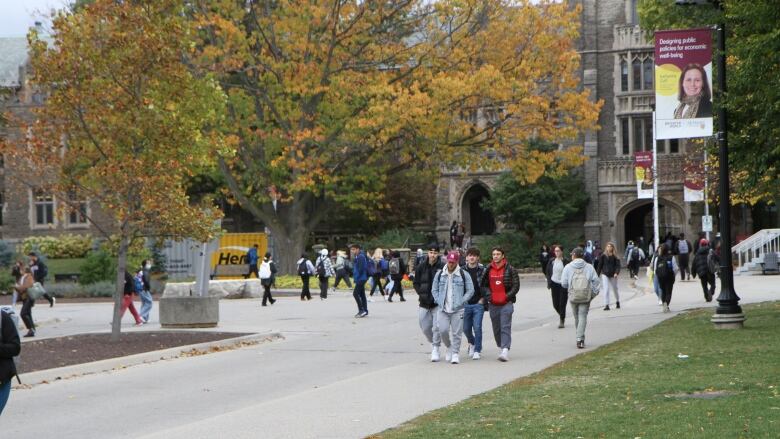 Many students are walking in between classes on campus.