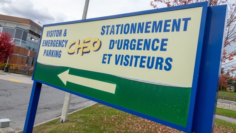 A sign pointing people to CHEO's visitor and emergency parking.