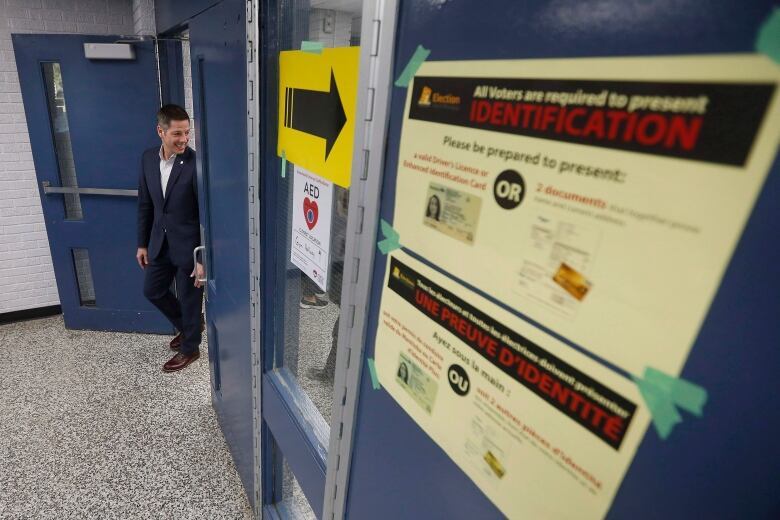 A man looks back as he walks out of a polling station.