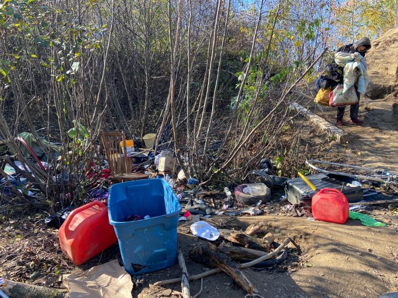 Various items lay strewn all over a wooded area.