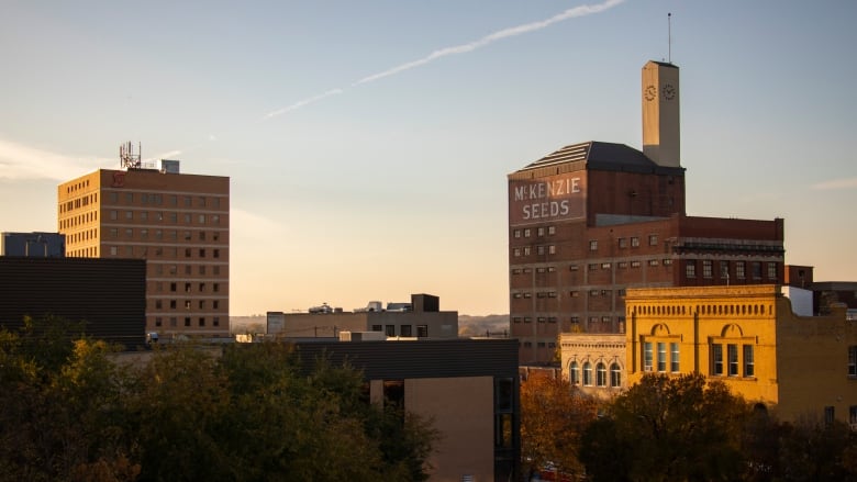 The sunsets on a the skyline of a downtown buildings.