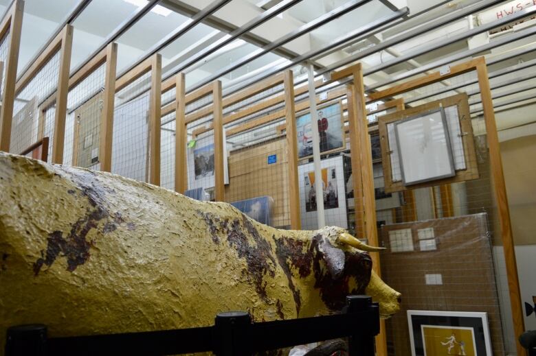 Paintings, photographs and a cow sculpture are among the pieces stored in the art storage room at the Regina Central Library.