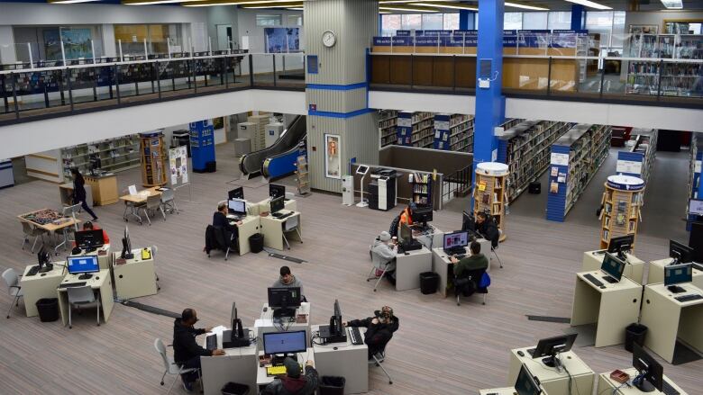 Patrons of the Regina Central Library use computers and browse books on Oct. 25, 2022. 