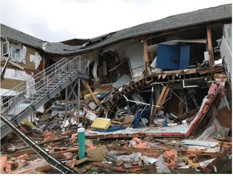 A completely leveled building with debris strewn around.