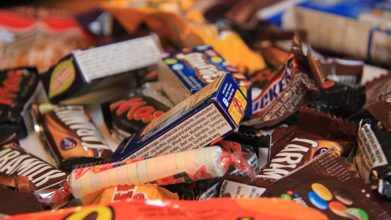 An assortment of Halloween candy and chocolate in wrappers.