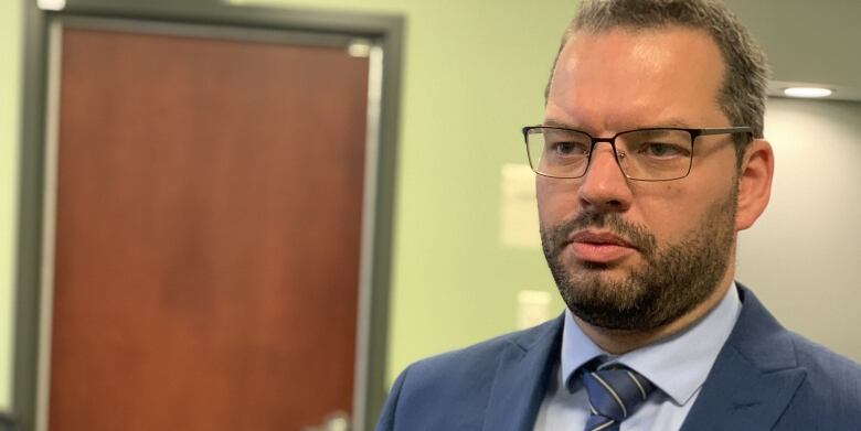 A man wearing glasses and a tie.