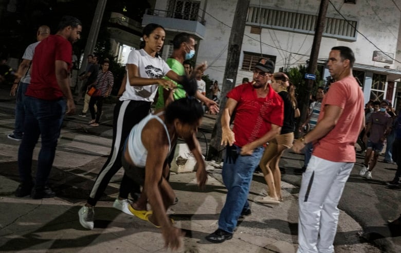 A plain-clothed police officer throws a woman to the ground during an anti-government protest in Havana, Cuba, Saturday, Oct 1, 2022. Although the democratic left is ascendant in Latin America, the Cuban Communist Party faces unprecedented challenges to its one-party rule. (AP Photo/Ramon Espinosa)