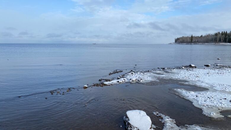 A view out over a lake from an icy shoreline.