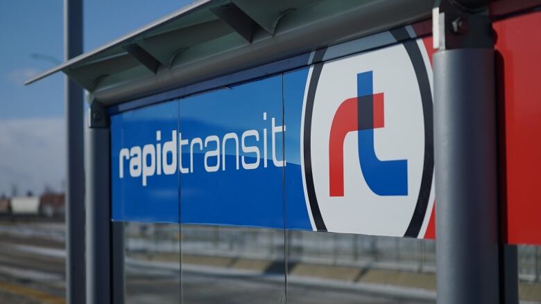 A closeup of a blue sign with white lettering reading 