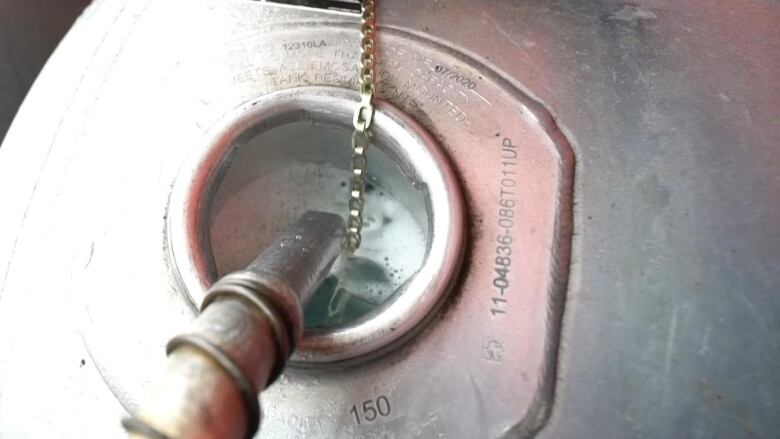 A diesel pump fills up a tank with fuel.