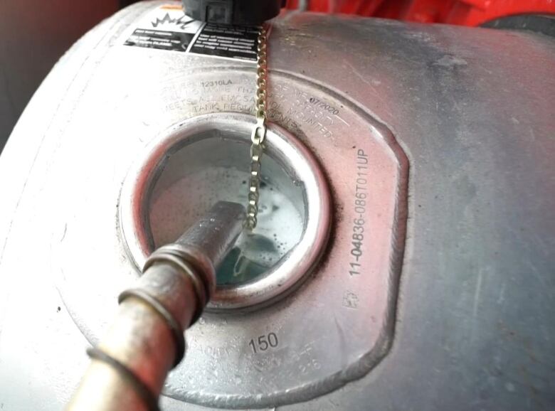 A diesel pump fills up a tank with fuel.