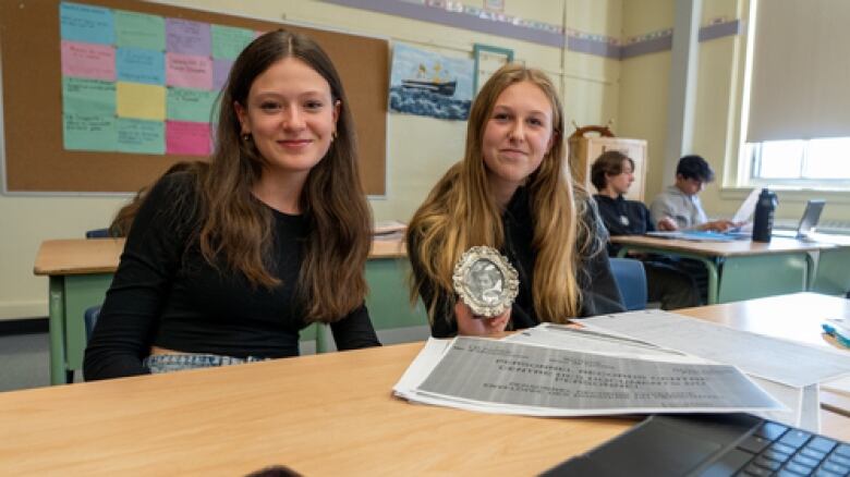 Two students at a desk.