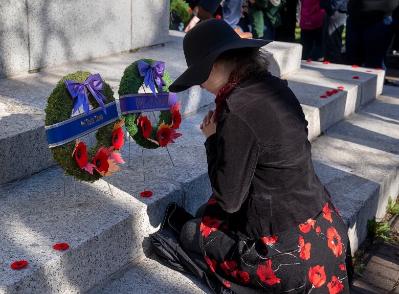 A woman pays her respects at Remembrance Day ceremonies at the Grand Parade in Halifax.