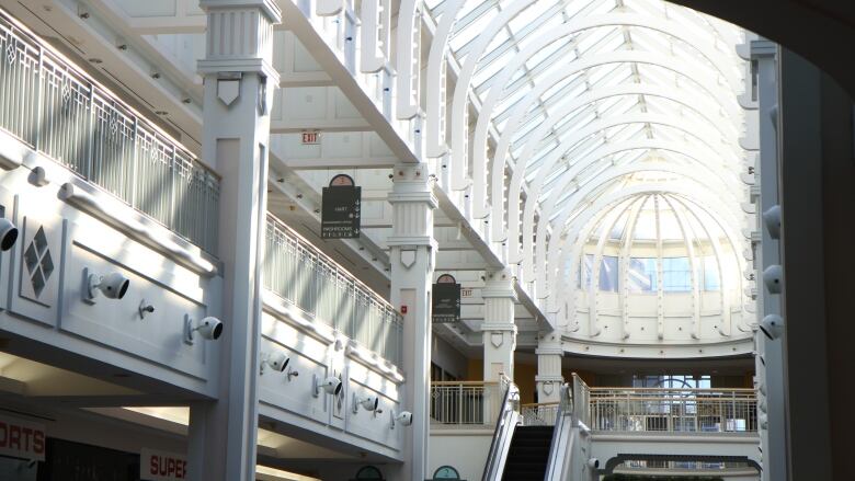 Skylights line the length of the mall, which is surrounded by balconies looking over a central courtyard.