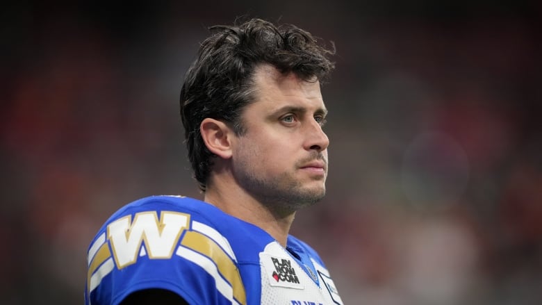 A football player is pictured looking forward, with his helmet off.