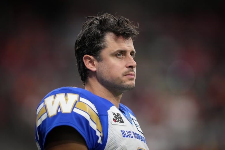 A football player is pictured looking forward, with his helmet off.