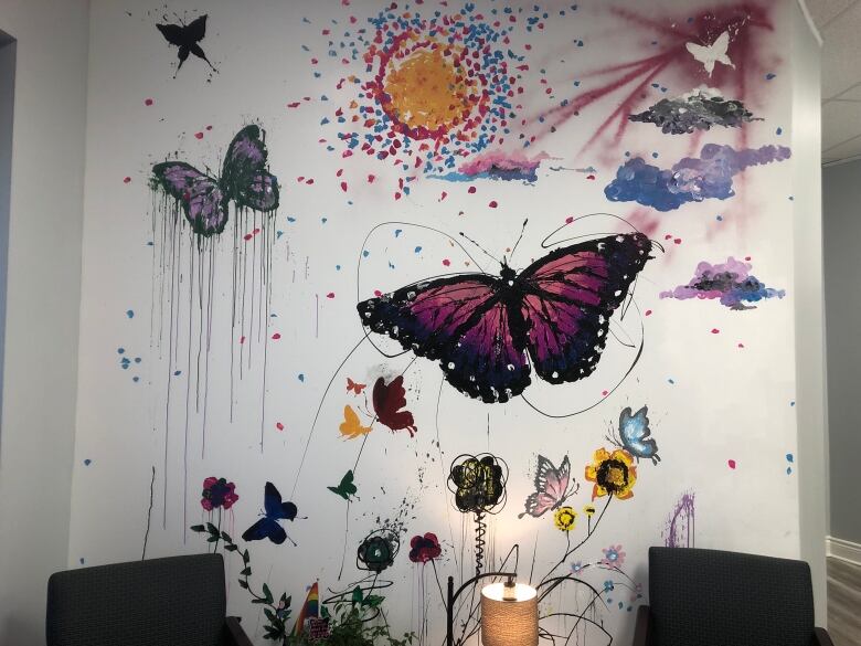 A wall with butterflies of different colours painted on it