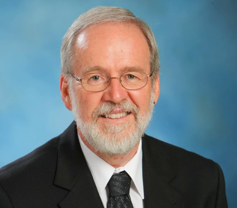 A photo of a man smiling at camera