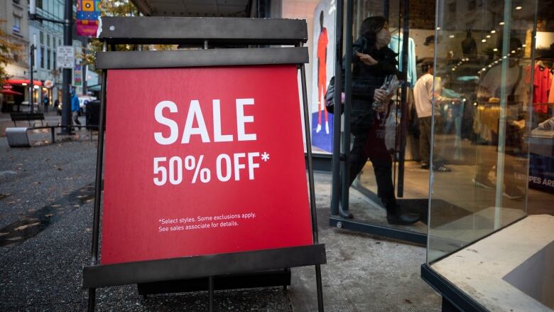 People are pictured shopping in downtown Vancouver, British Columbia on Tuesday, November 22, 2022. 