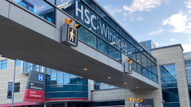 Car drive by Winnipeg Health Sciences Centre adult emergency entrance in early winter.