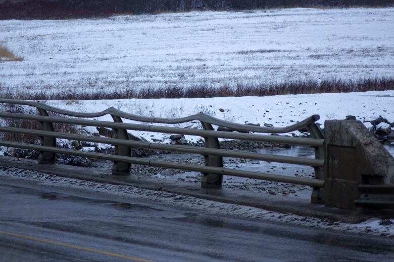 Warped guard rails on the a two-lane bridge.