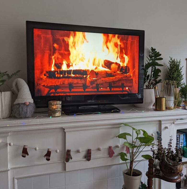 a fireplace film plays on a TV