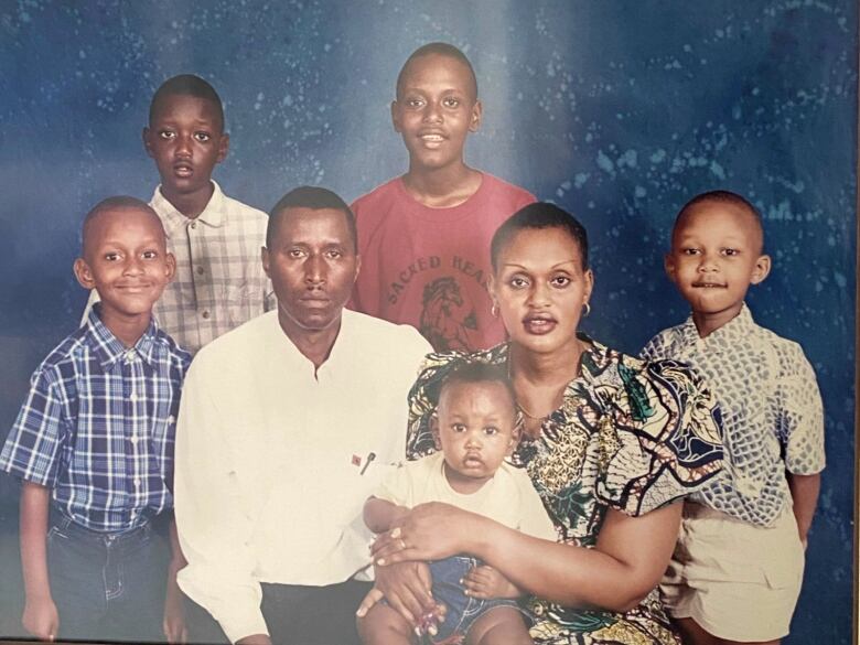 A studio portrait of a father, mother and five boys. 