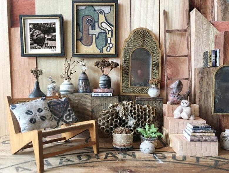 Living room tableau made of tiny home furnishings in earth tones.