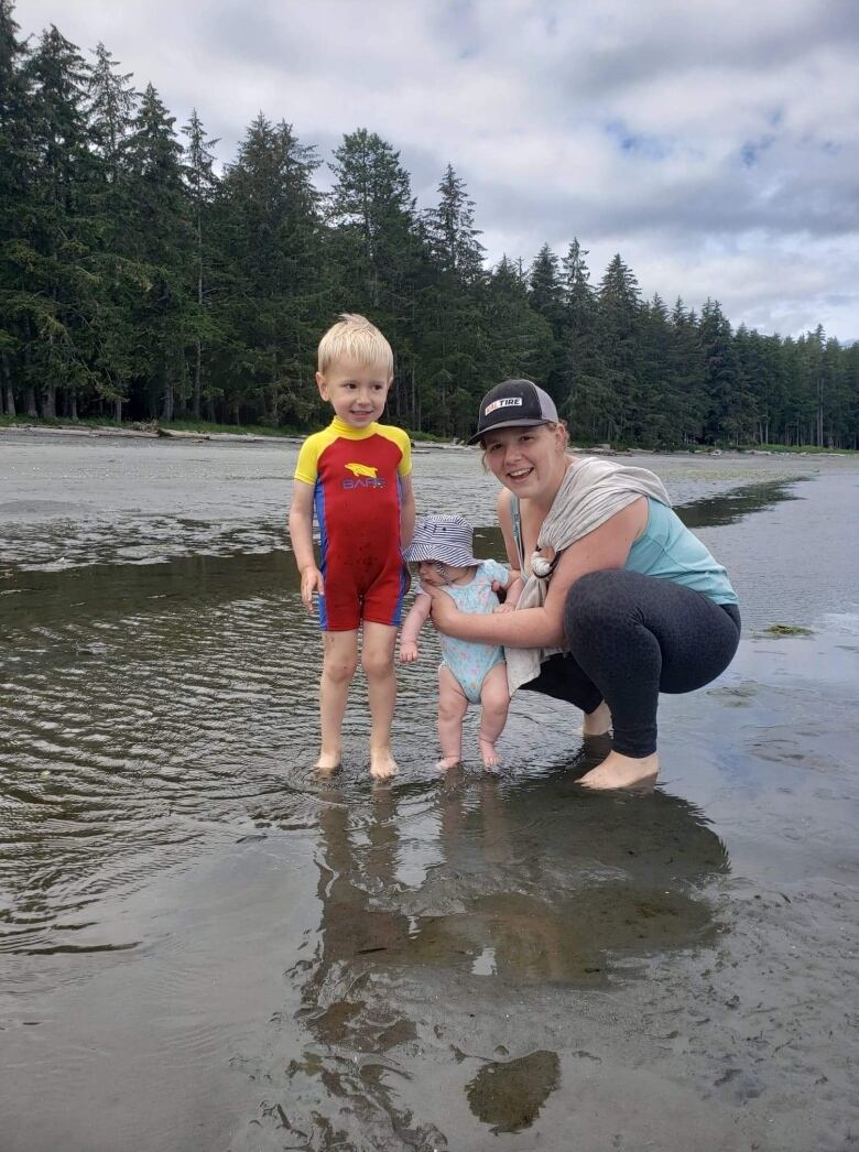 Darci Kostiuk is at the beach with her two children. 