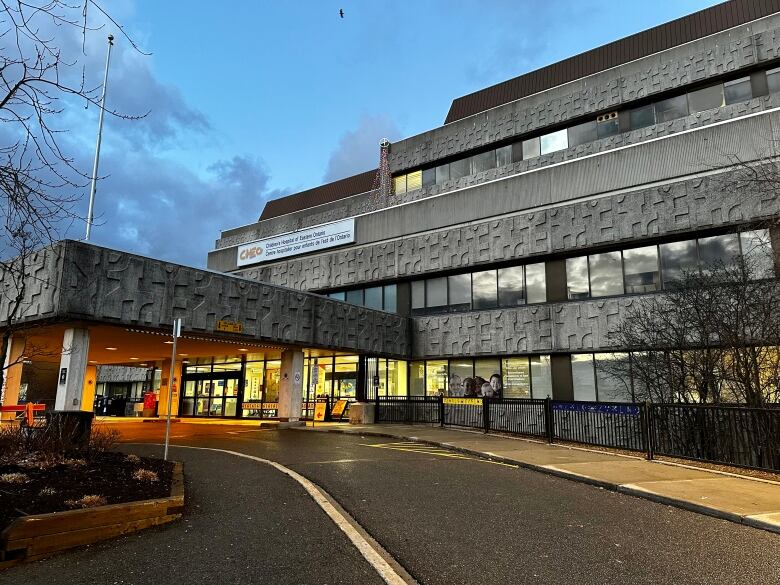 The entrance to a hospital at dusk.