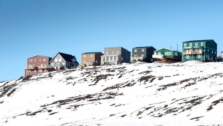 A row of houses overlook a hill in Iqaluit.