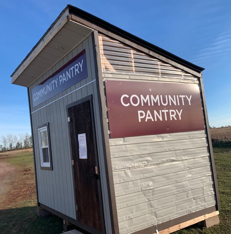 Food pantry structure with a sign 