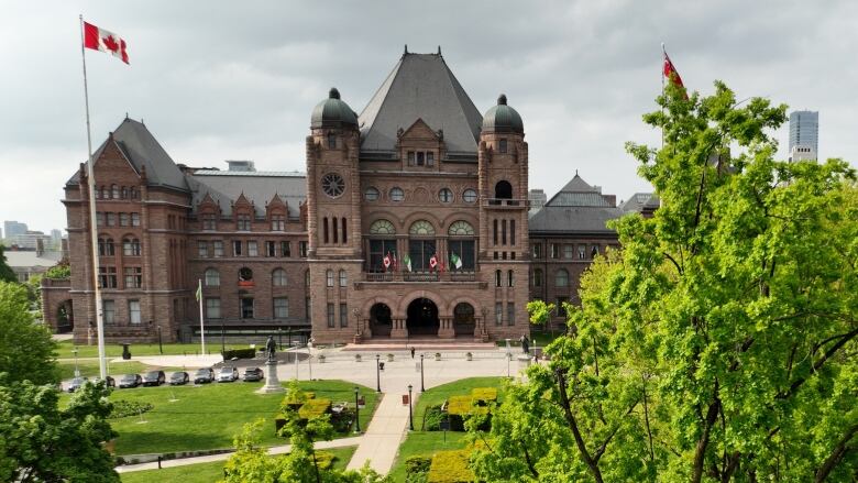 An aerial view showing a government building in the background and trees in the foreground.