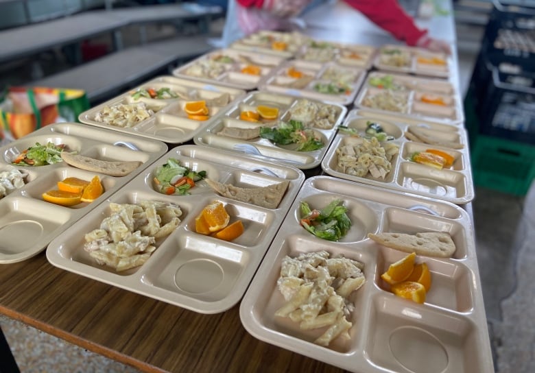 A table holding trays with food items. 