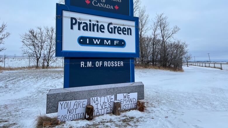 A sign in a field reads 