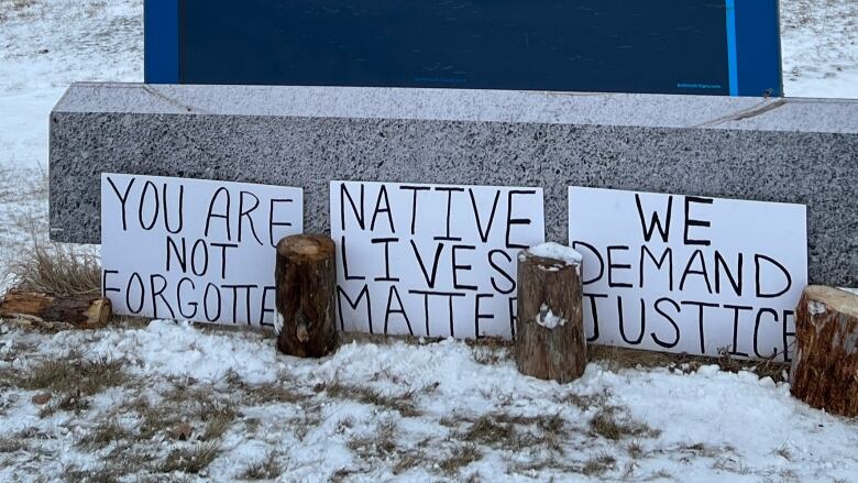 Handwritten signs reading 