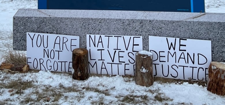 Handwritten signs reading 