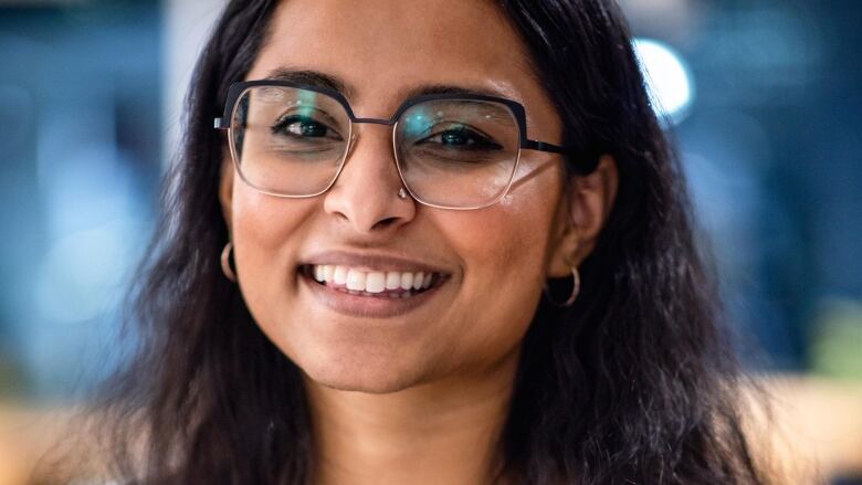 A woman smiles at the camera.