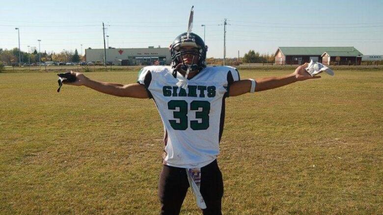 Tyree Cayer shows off his Elmwood Giants uniform in his high school football-playing days.