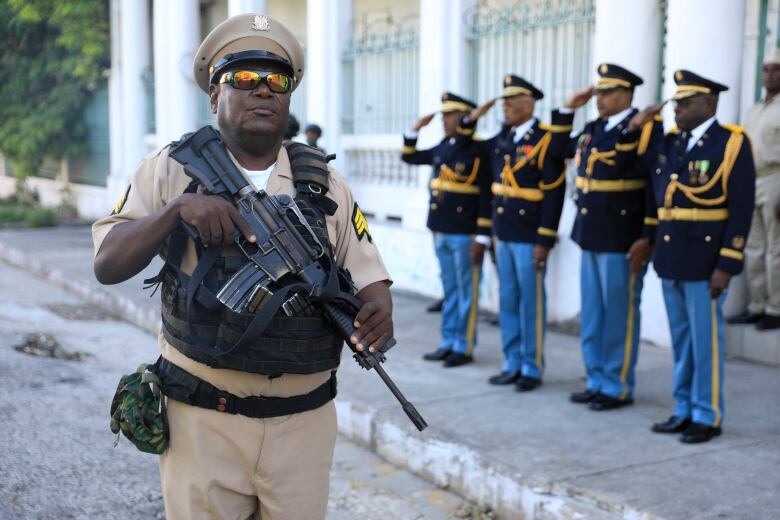 Soldiers of the Haitian Armed Forces stands guard during a ceremony to mark the anniversary of the Battle of Vertieres, the last major battle of Haitian independence from France, at Army headquarters in Port-au-Prince, Haiti on Nov. 18, 2022.