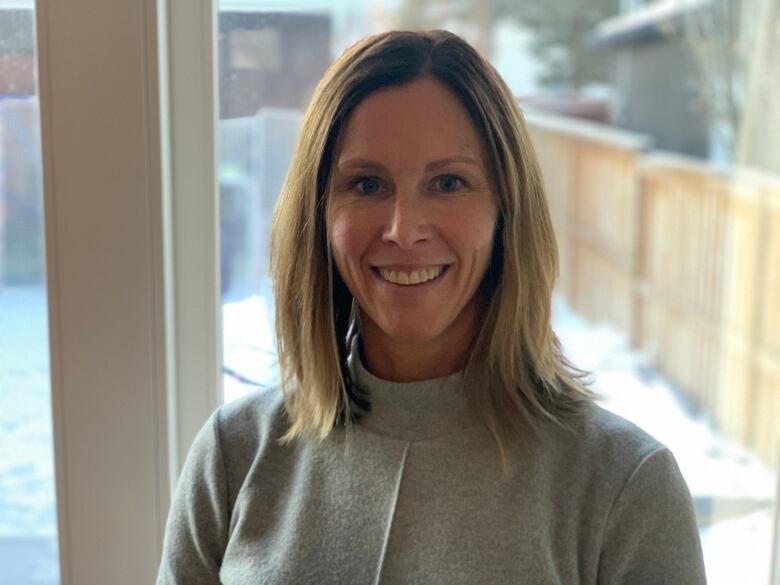 A portrait of Dr. Michaela Walter, standing in front of a window 