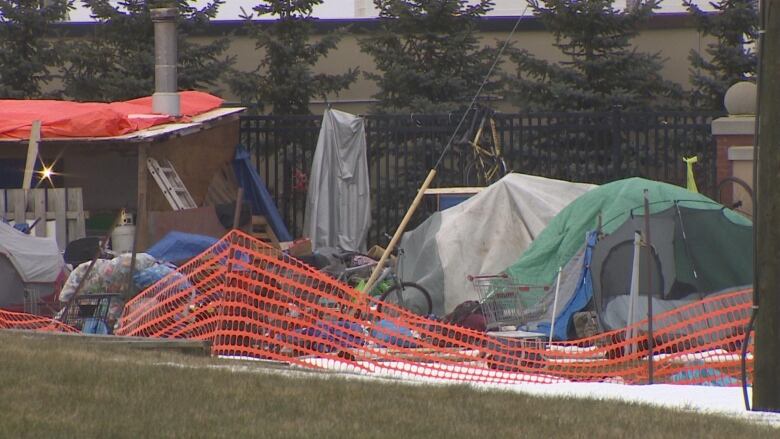 Tents, tarps and other makeshift shelters make up a homeless encampment. 