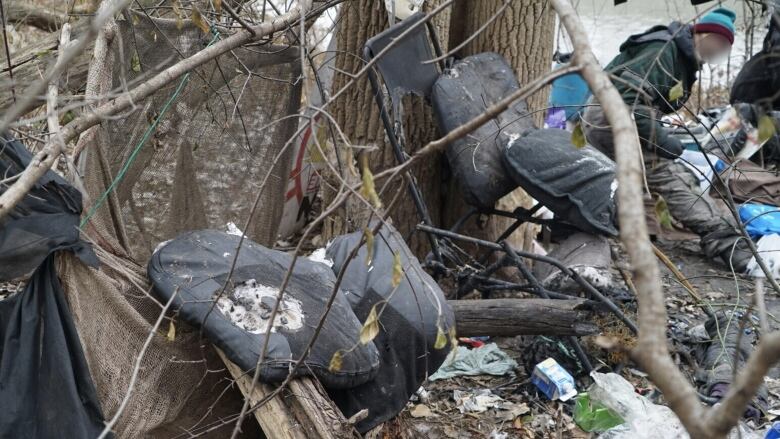 A homeless man sifts through what's left of his possessions after a fire destroyed his encampment in downtown London, Ont. It's a scene that's becoming more common, increasing the likelihood of injury and keeping firefighters on their toes. 