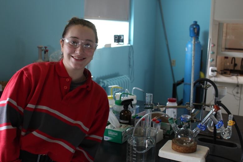 Sarah Martell, a PhD candidate in the Dasog lab, stands with a setup that produces hydrogen on demand with the use of powdered silicon.